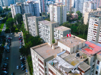 Aerial Drone View over Jesús María with Building Featuring a Waving Peruvian Flag.