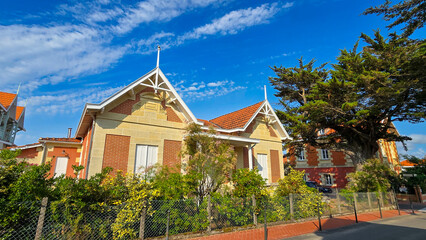 Fototapeta premium One of the streets and picturesque villa of the charming town Soulac sur Mer in France on the Atlantic coast. Typical architecture of the Frenches resort town.