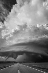 A mesocyclone spins across the Western Nebraska sandhills with a road leading into the distance.
