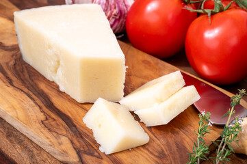 Pieces of matured pecorino romano italian cheese made from sheep milk in Lazio, Sardinia or Tuscany