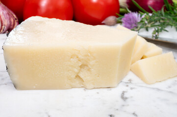 Pieces of matured pecorino romano italian cheese made from sheep milk in Lazio, Sardinia or Tuscany