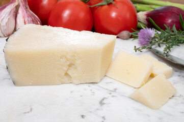 Pieces of matured pecorino romano italian cheese made from sheep milk in Lazio, Sardinia or Tuscany