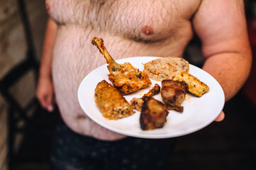 Close-up photo of food. Fat man, skinny waiter holding tasty fresh fried chicken, pork, grilled...