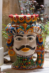 Sicilian folk art, traditional flower pots in  form of heads, colourful hand-painted pottery,...