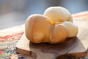 Italian semi hard handmade white and smoked scamorza cheese, from cow milk from Apulia or Calabria regions close up