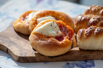Fresh baked bread, pizza, focaccia or pizzetta with tomatoes, vegetables, sausage and cheese, street food in Palermo, Sicily, Italy, served outdoor for lunch