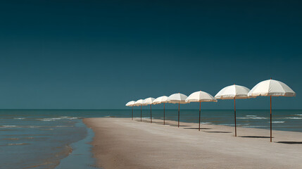 Obraz premium A row of white umbrellas are lined up on a beach