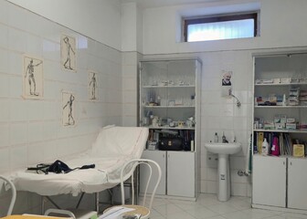 Old-fashioned Italian medical room with anatomy prints, tiled walls, classic desk and medicine cabinet. Rome, Italy, July 13, 2025