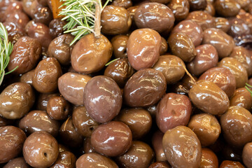 Homemade italian pickled black olives with garlic and spices on food market in Palermo, Sicily, italy