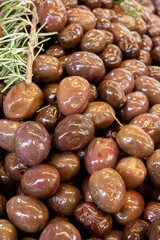 Homemade italian pickled black olives with garlic and spices on food market in Palermo, Sicily, italy