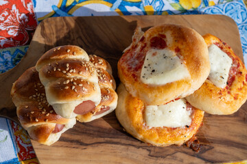 Fresh baked bread, pizza, focaccia or pizzetta with tomatoes, vegetables, sausage and cheese, street food in Palermo, Sicily, Italy, served outdoor for lunch