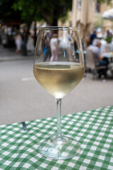 Drinking of cold italian grillo white wine with view on old street of Palermo, Sicily, Italy, lunch with wine