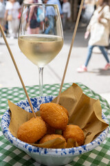 Arancini Sicilian, deep-fried rice balls made with risotto, filled with ingredients mozzarella, ragu, peas, coated in breadcrumbs fried to crispy, brown on market in Palermo, Sicily