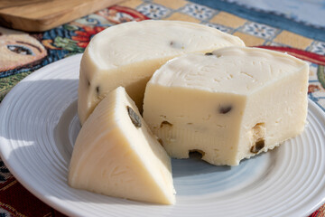 Primo Sale hard cheese made from whole mixed milk, with thin white rind and texture of Sicilian basket fascedde with pickled capers