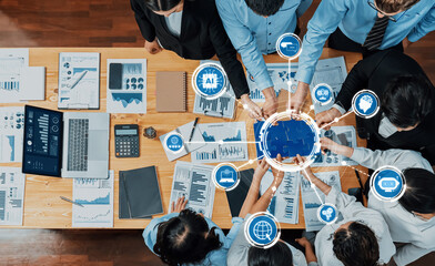 A diverse group of professionals collaborates in a modern office, engaging with technology and...