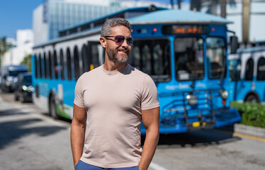 Hispanic tourist at bus station. Tourist man on city street. Traveler tourist man in casual clothes...