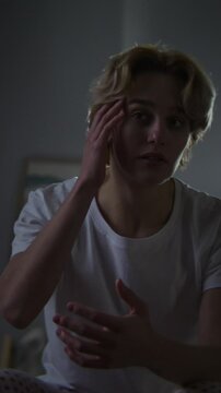 Pensive woman looks at lace reflection sitting by mirror