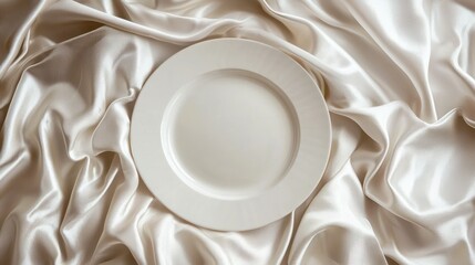 Empty plate on draped satin