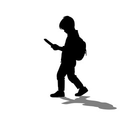 Silhouette of child walking while holding smartphone with backpack  