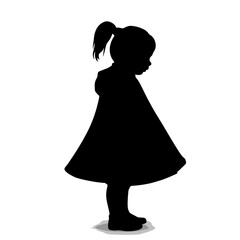 Silhouette of a girl wearing a dress standing in profile  