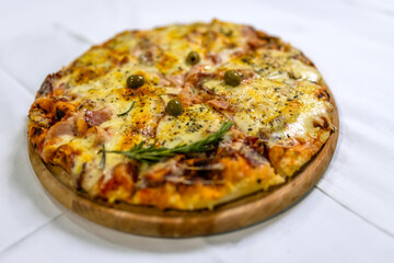 Delicious Pizza Capricciosa with Olives and Cheese on Table