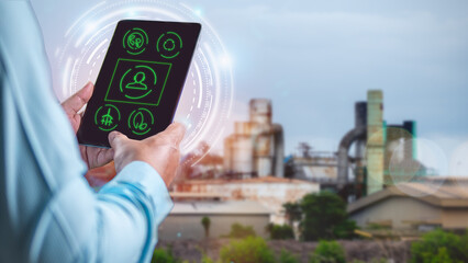 Engineer Monitoring Industrial Processes with Tablet, Industrial Automation and Smart Factory Concept, Environmentally friendly factory.