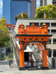 Historic Angels Flight funicular at its lower station, surrounded by modern skyscrapers and urban greenery in downtown Los Angeles, California, USA
