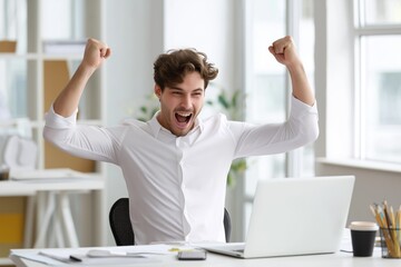 Excited young businessman celebrating success at laptop in modern office – achievement and startup concept imagery