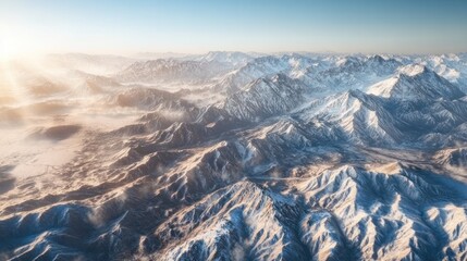 Obraz premium High-altitude view of snow-capped mountain ranges at sunrise
