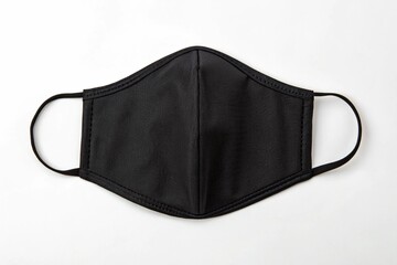 Essential black face mask offering protection with elastic ear loops on white background.