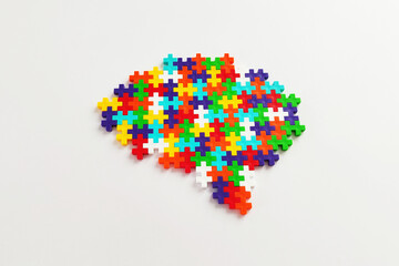 Brain shaped colorful jigsaw puzzle on white background.