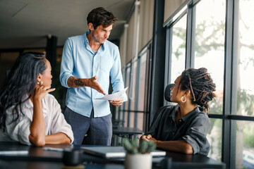 Colleagues arguing at workplace, executives disagree about papers, found error in contract