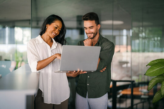 Busy smiling executive business team using digital devices in office. Diverse professional people