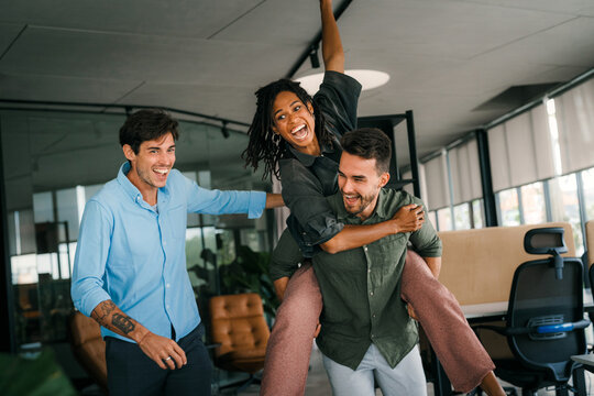 Group of young multiracial diverse office workers is caught in a moment of spontaneous joy. - Powered by Adobe