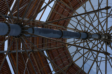 Steel construction of observation tower with radial metal beams and bolts viewed from underneath...