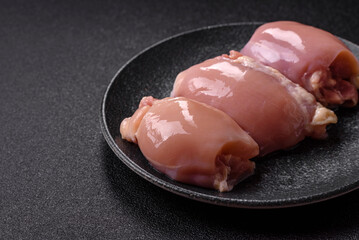 Raw chicken thigh fillet without skin and bone with salt and spices. Raw chicken fillet for cooking