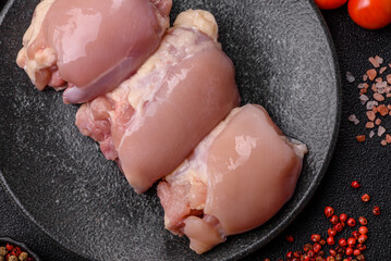 Raw chicken thigh fillet without skin and bone with salt and spices. Raw chicken fillet for cooking