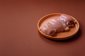 Raw chicken thigh fillet without skin and bone with salt and spices. Raw chicken fillet for cooking
