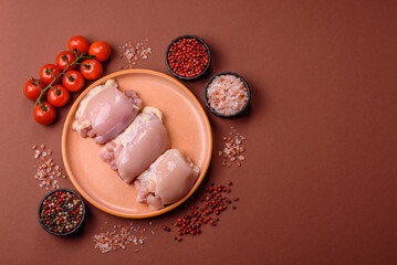 Raw chicken thigh fillet without skin and bone with salt and spices. Raw chicken fillet for cooking