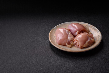 Raw chicken thigh fillet without skin and bone with salt and spices. Raw chicken fillet for cooking