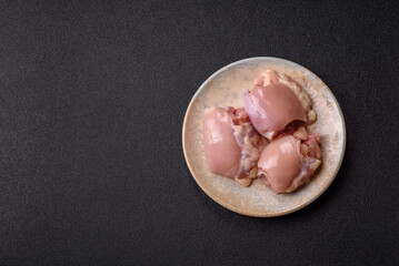 Raw chicken thigh fillet without skin and bone with salt and spices. Raw chicken fillet for cooking