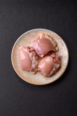 Raw chicken thigh fillet without skin and bone with salt and spices. Raw chicken fillet for cooking
