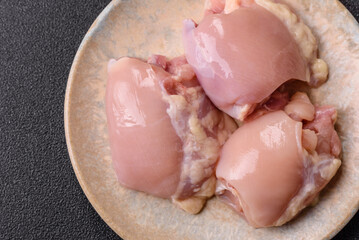 Raw chicken thigh fillet without skin and bone with salt and spices. Raw chicken fillet for cooking