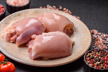 Raw chicken thigh fillet without skin and bone with salt and spices. Raw chicken fillet for cooking