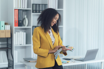 Efficiency and Professionalism: A composed woman in a formal blazer stands in a brightly lit...