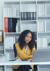 Focused Professional Woman: A dedicated woman, engrossed in her work at a modern office, embodies...