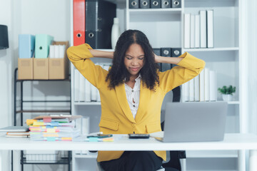 Reaching Limits: An office worker experiences a moment of weariness, head resting on crossed hands...