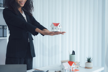 Real Estate Agent Presenting House Model