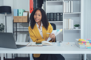 Online Collaboration: Captivating image of a smiling woman at her desk during an online meeting,...