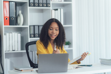 Focused Professional in Office: A portrait of a focused business woman in a well-lit office...